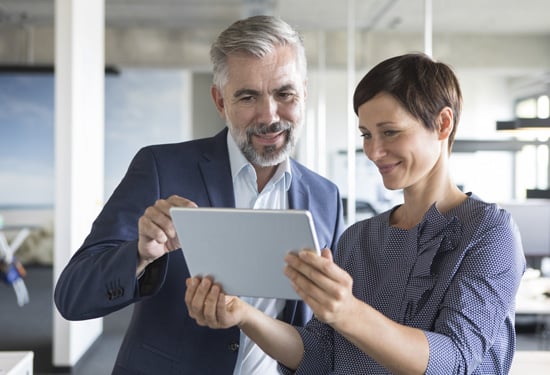 two people looking at tablet