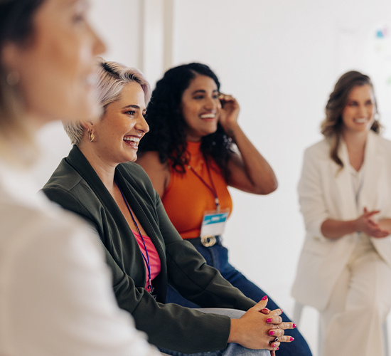 women smiling during a presentation