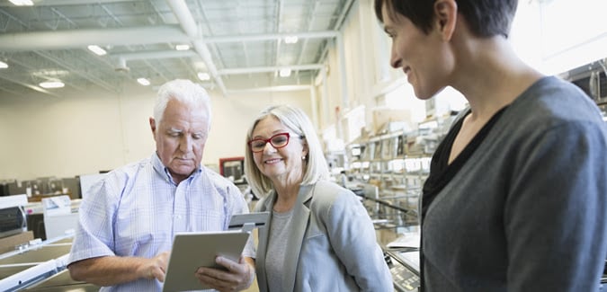 couple looking at tablet in store