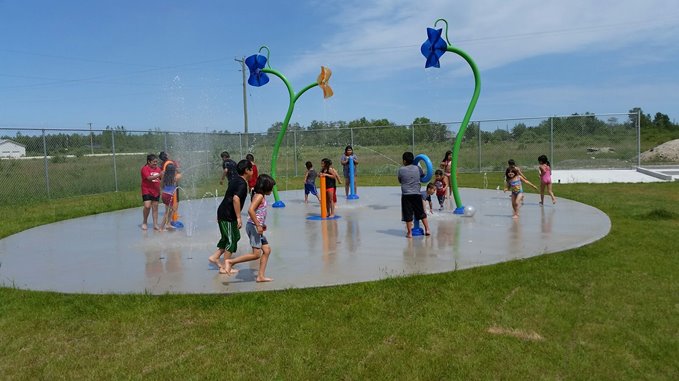 kids playing at sandy bay's splash pad