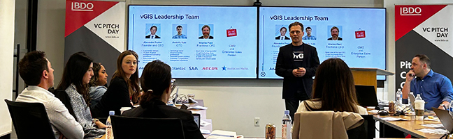 Businesspeople watching a presentation on a screen in a conference office.