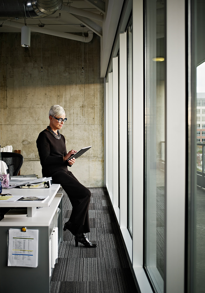 woman looking at ipad in office