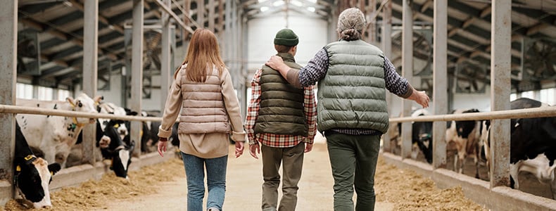 family of farmers inside their barn