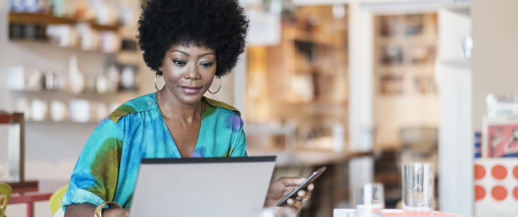 woman on computer and phone