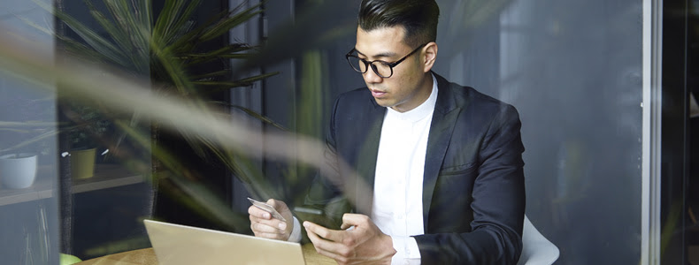 person on phone and laptop