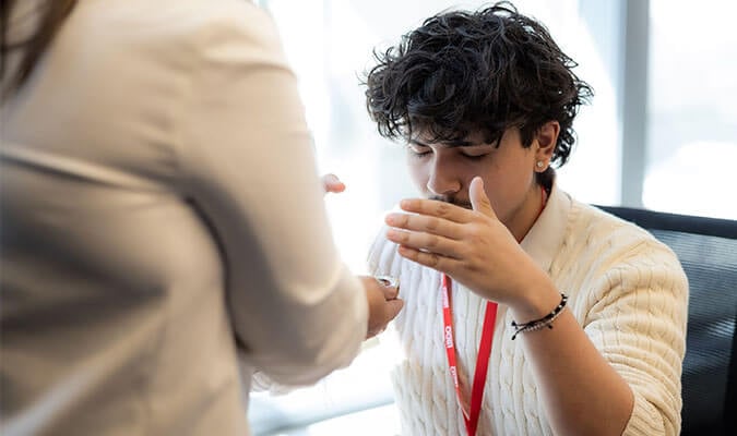 Étudiant prenant part à une cérémonie de purification lors de la journée d’accueil des participants du programme pour étudiants autochtones de BDO Canada.