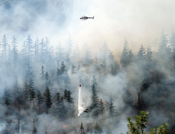 forest fire with helicopter above