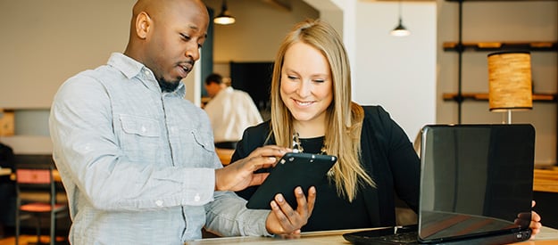 two people looking at tablet