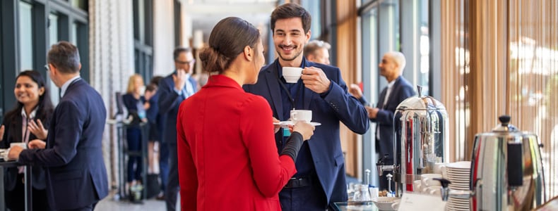 focused on two people at event drinking coffee